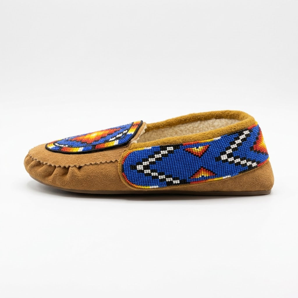 Side view of a tan cow suede Morning Star moccasin showing the blue and white zigzag beaded collar panel and rubber sole.