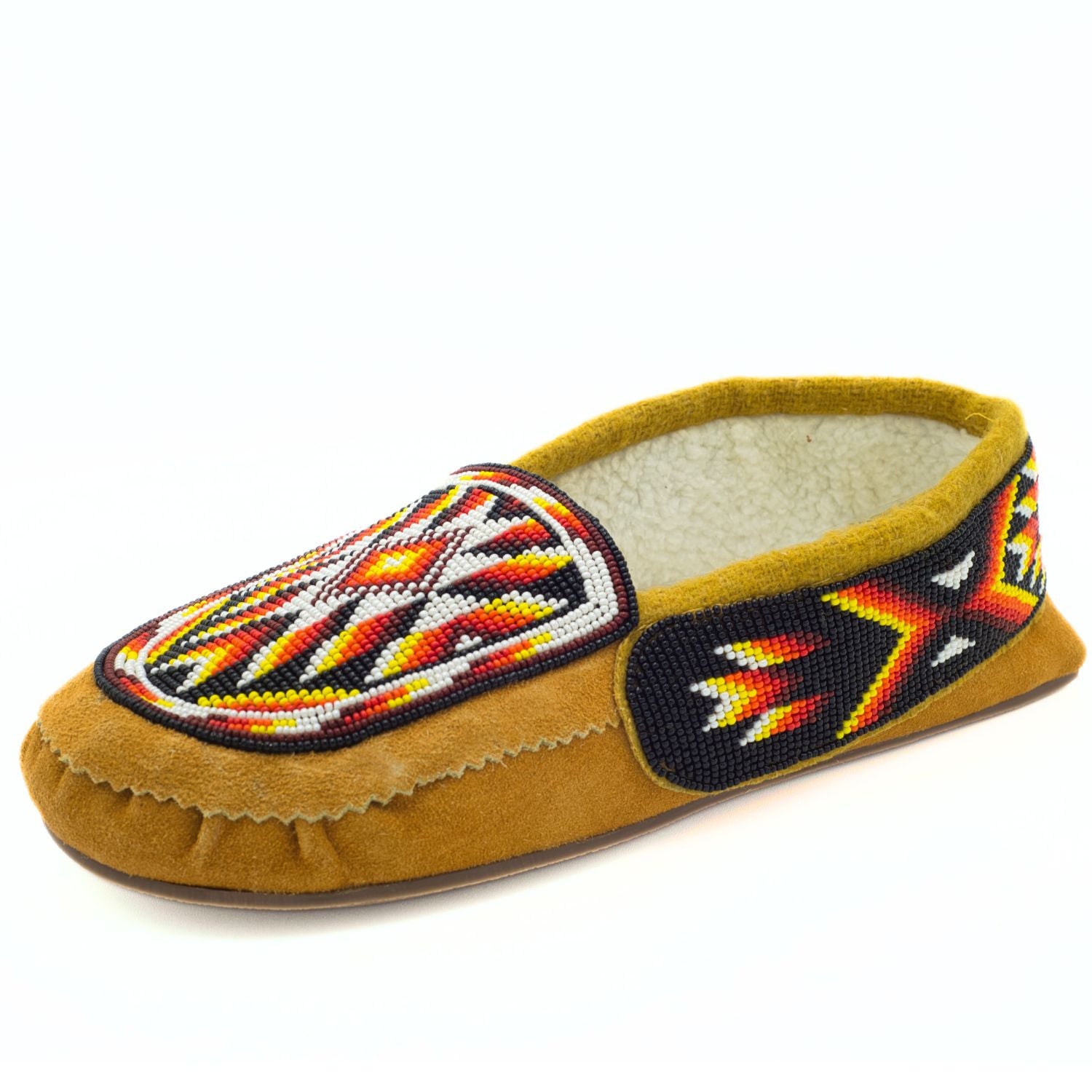 A single tan cow suede slip-on moccasin with red, orange, and yellow thunderbird flame beadwork, a mustard-gold fleece-lined collar, and rubber sole, shown on a white background.